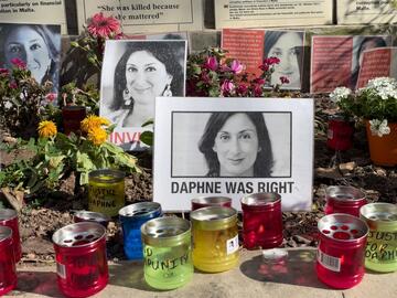 Valletta, Malta - April 17th 2022: Photographs, candles and messages left at the base of the Great Siege Monument demanding justice for the journalist Daphne Caruana Galizia who was murdered in 2017. Pablo L Mendoza - Shutterstock.