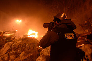 Journalist documenting events at the Independence square. Clashes in Ukraine, Kyiv. Events of February 18, 2014.
