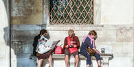 Women reading newspapers in Venice, Italy © travelview/Shutterstock