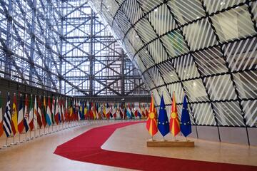 European union flag and flag of Macedonia in the EU council building © Shutterstock